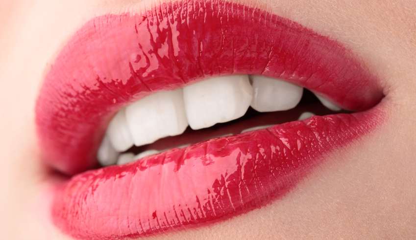 rote Lippen und weiße Zähne einer jungen Frau